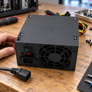 Fuente de poder ATX Unitec referencia 750W negra — fuente negra sobre banco de reparación